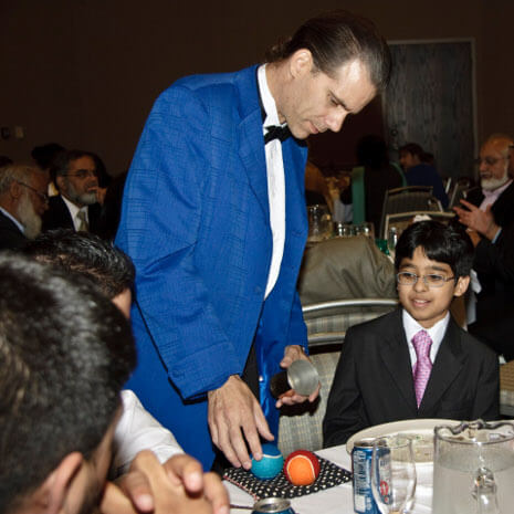 Chicago close-up magician performing cup and balls magic trick!