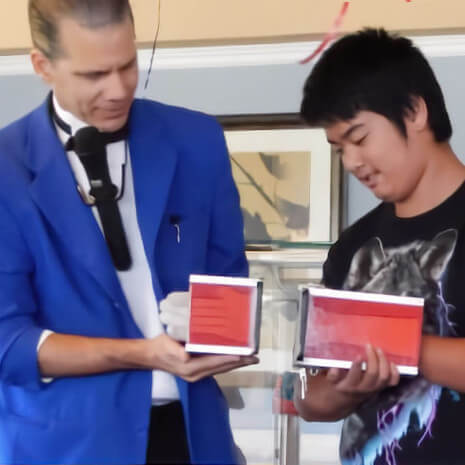 Magician and illusionist Fabjance performs a magic trick with a Chicago area kid!
