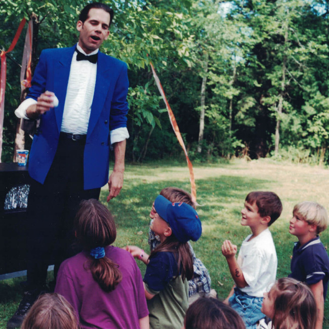 Chicago magician performs his magic at a kid's summer camp.
